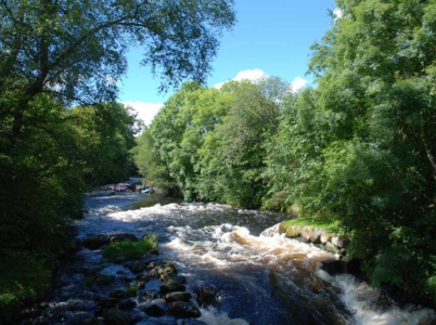 Blues skies above the stunning River Tryweryn and white water rafting next door to Tyn Cornel Camping